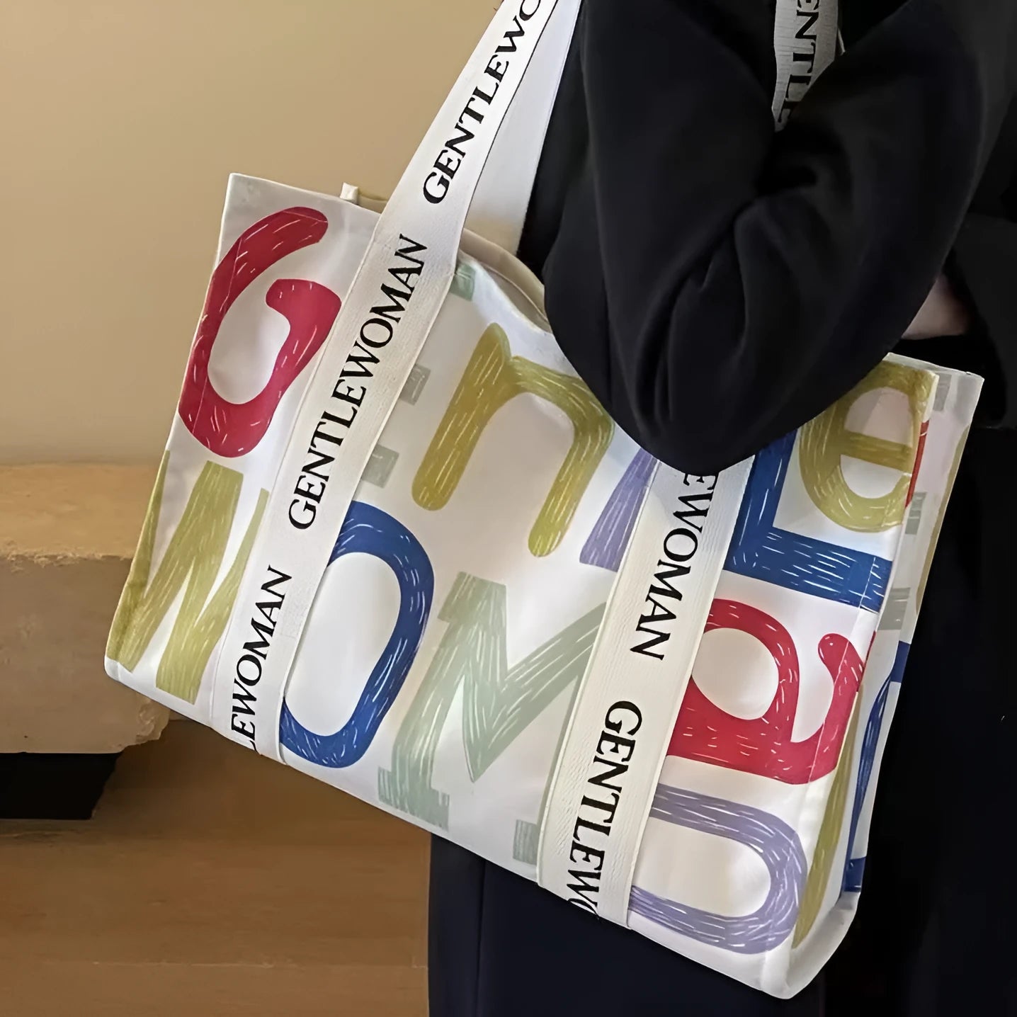 Large canvas tote shoulder bag with printed design in black letter, coloured letter, and pattern styles.