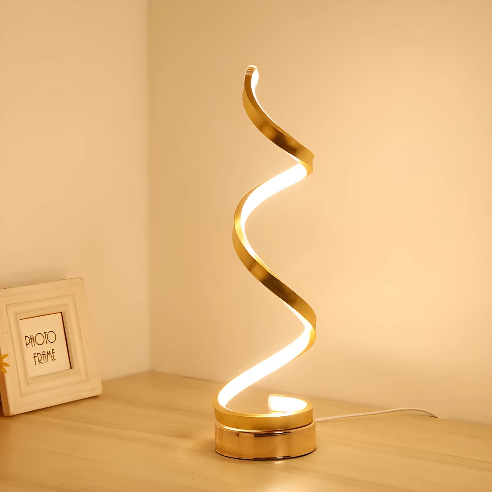Minimalist black LED table lamp with aluminium shade on bedside table