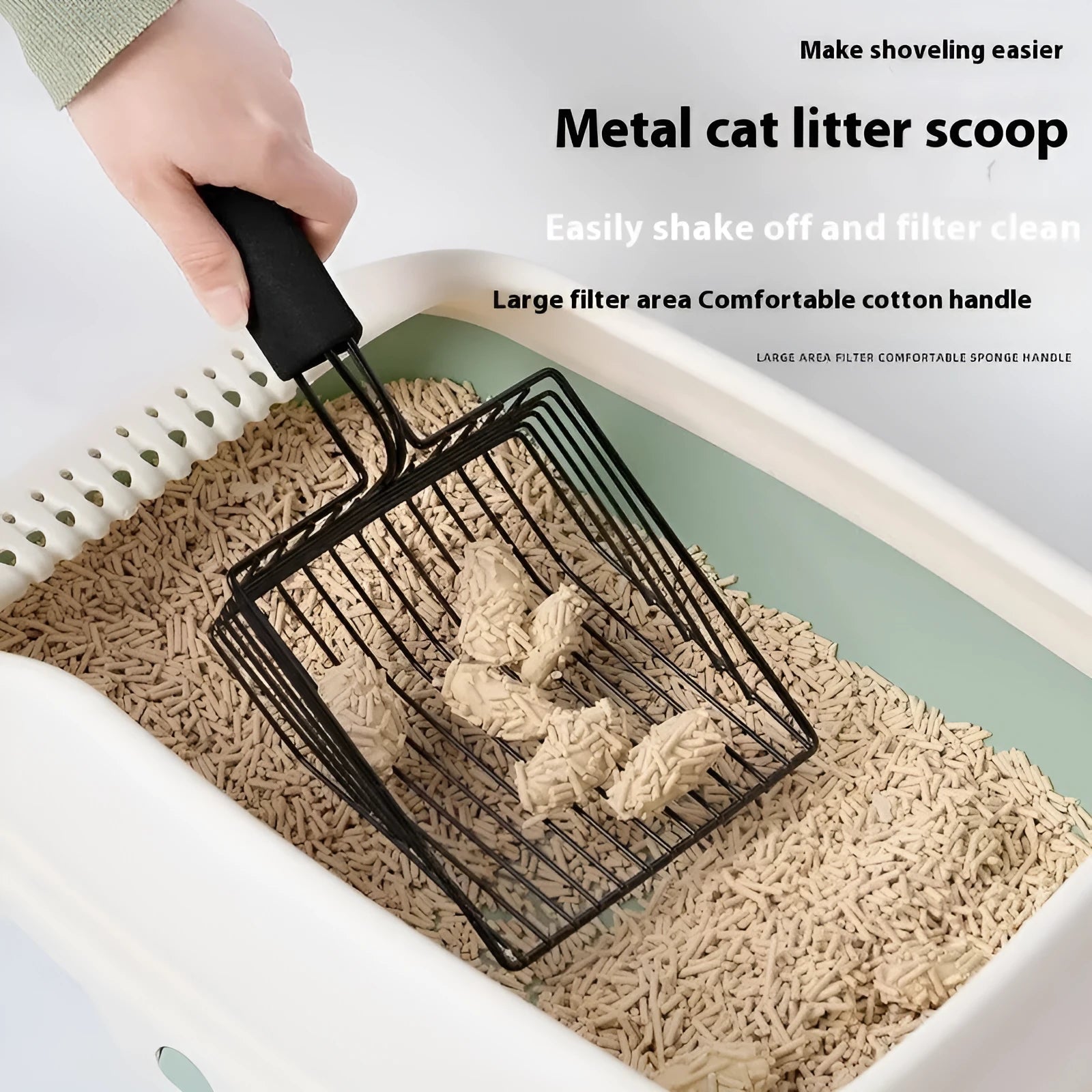 Black metal cat litter scoop with narrow tines for sifting clumping cat litter.