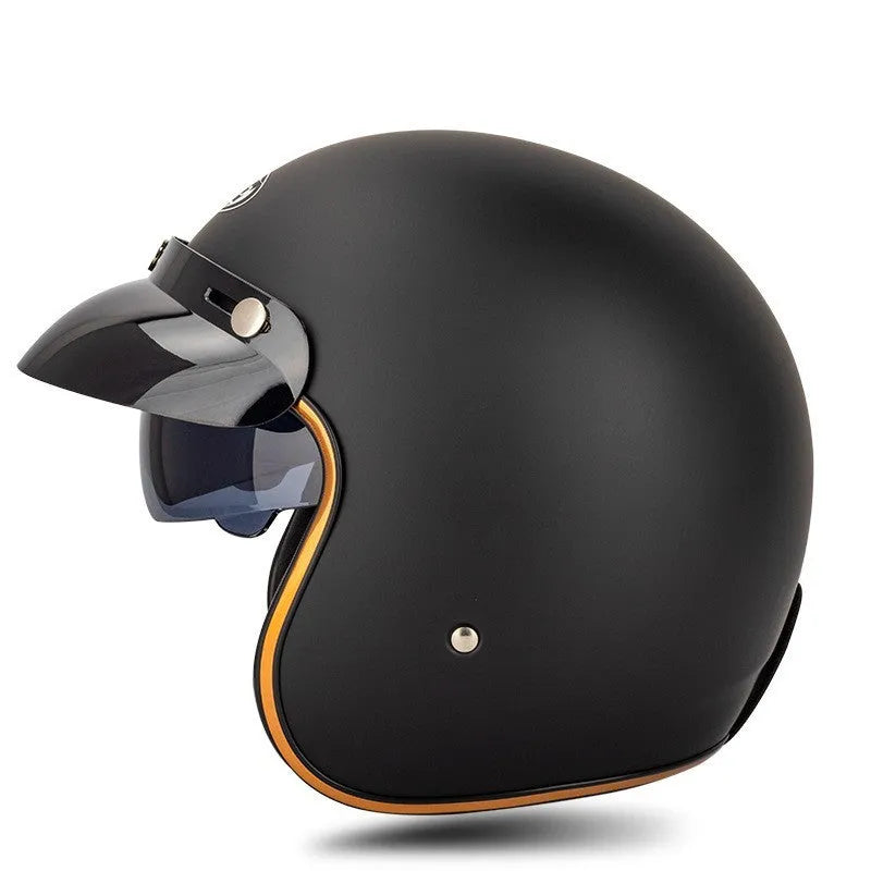 Retro-style black and orange open-face motorcycle half helmet for adults on a white background.