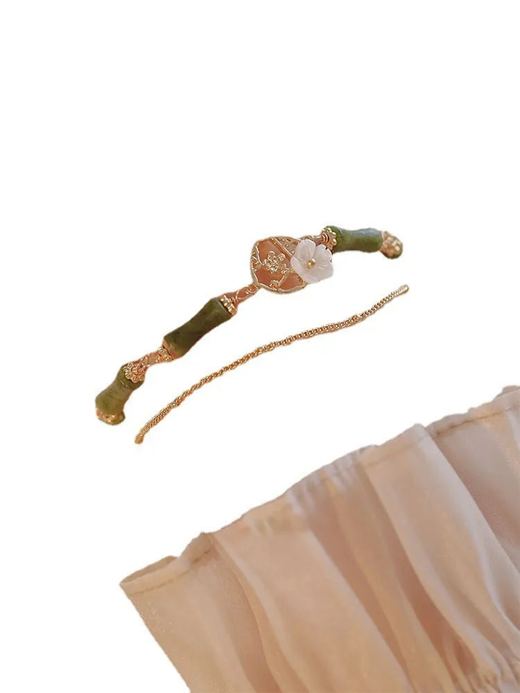 Handmade olivine bracelet with double layer design and twin charms on wrist