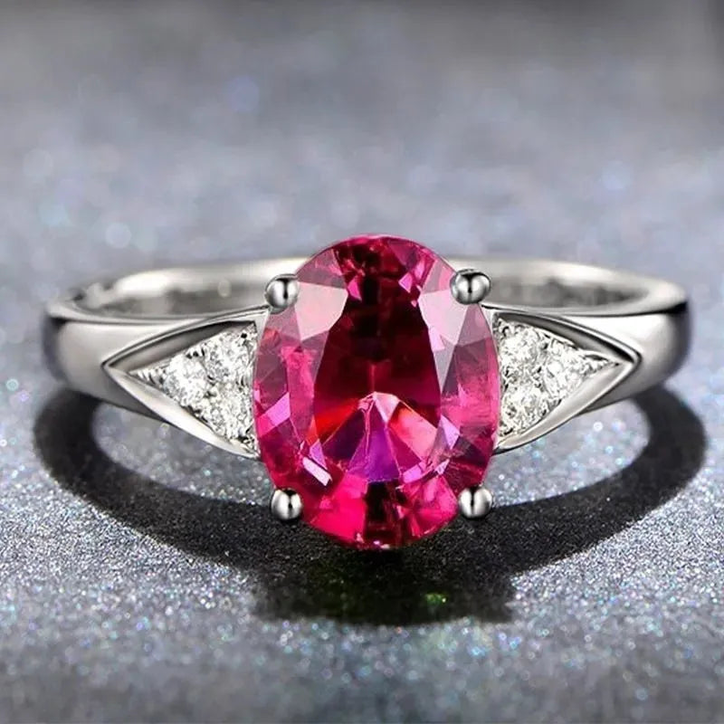Women's court style ring with natural zircon inlay in heart, drop, or bell pattern, in blue, green, light blue, or red.