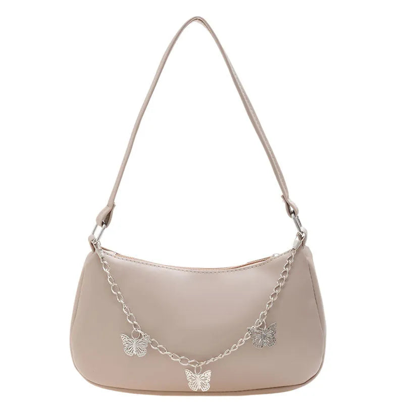 Butterfly chain underarm bag in black PU leather with crossbody strap and internal organisation pockets