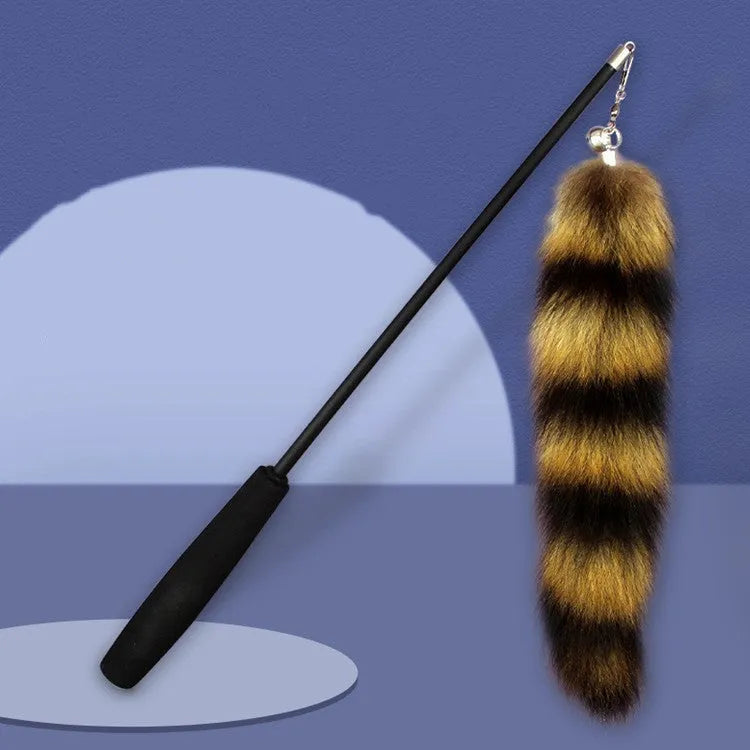 Black cat toy wand teaser with long elastic string stretched out for play.