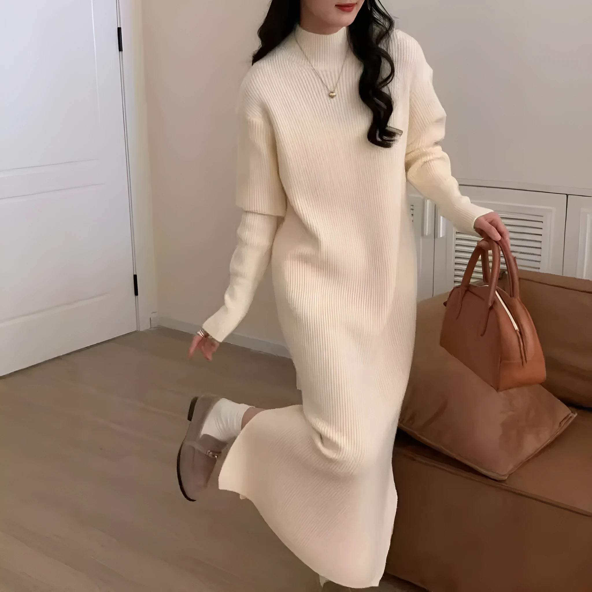Half turtleneck long sleeve knitted dress in a solid colour, shown in a high-waisted midi length.