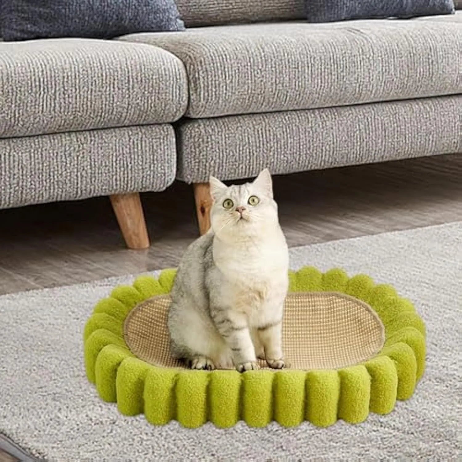 Green oval-shaped cat scratching pad with sisal fabric, serving as a lounge bed for cats.