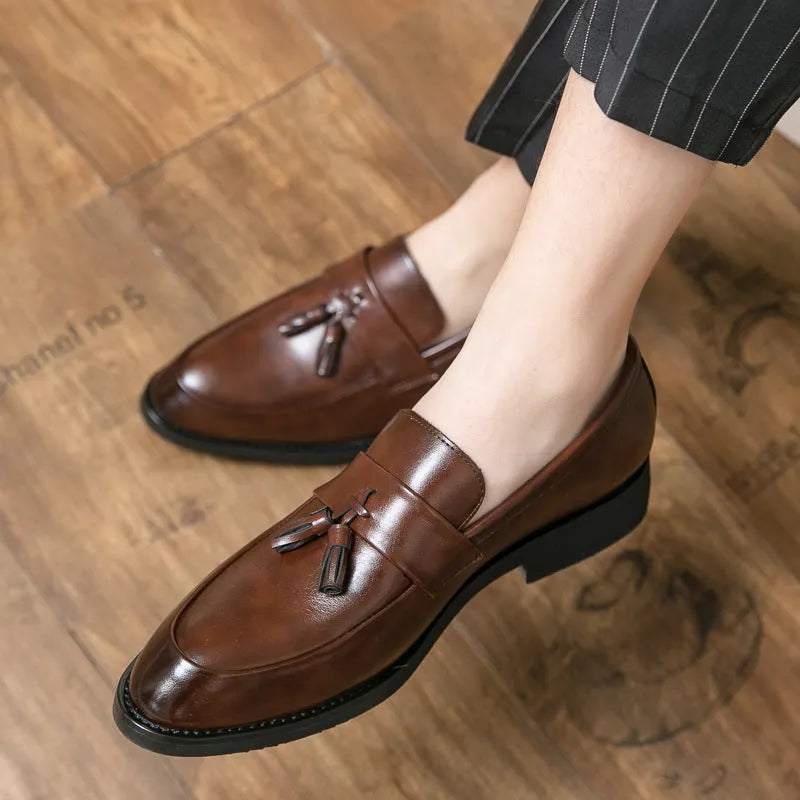 Men's black slip-on tassel loafers with low-top design and rubber sole for business casual wear