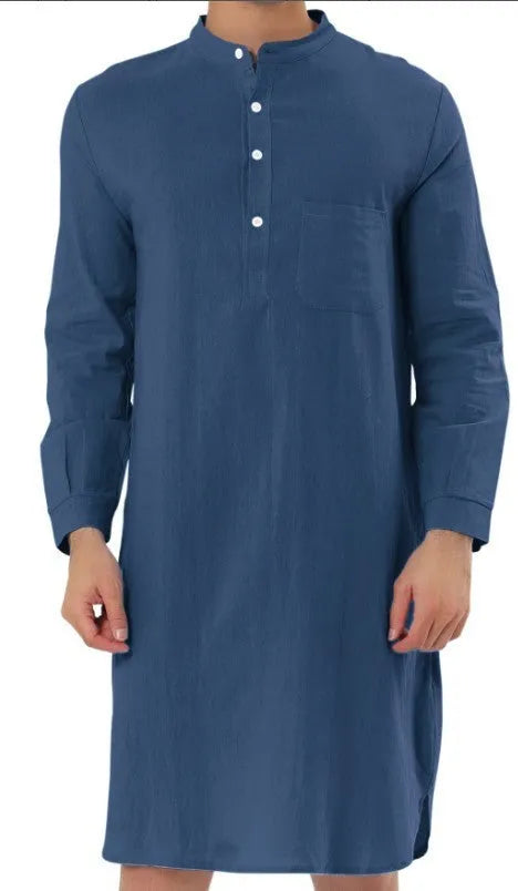 Man wearing a dark blue cotton shirt robe with a button front and chest pocket.
