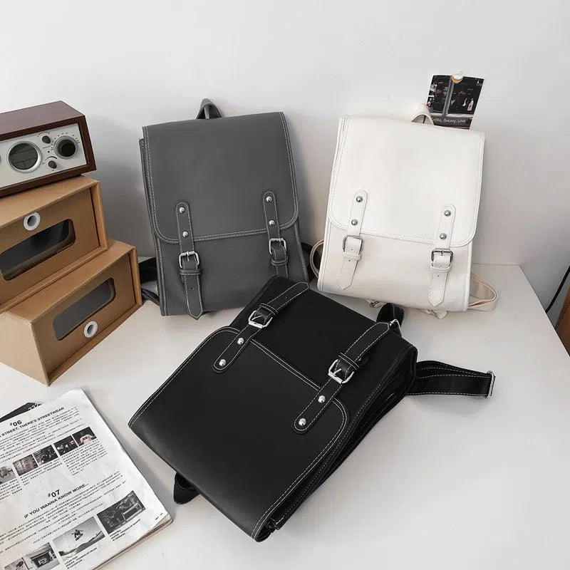 PU leather motorcycle-style buckle laptop backpack with geometric pattern in black, gray, and white, 20-35 litres capacity