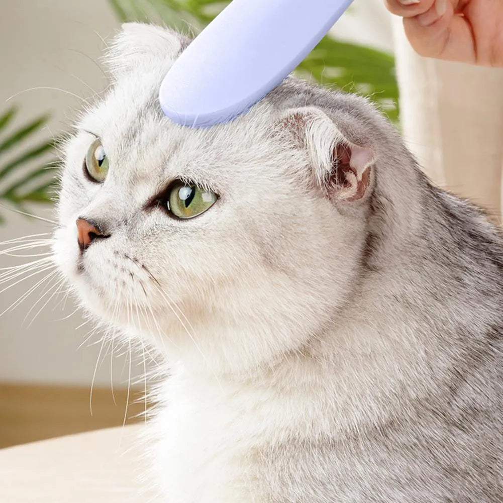 Grey cat grooming comb with tongue massager design showing narrow and wide ends