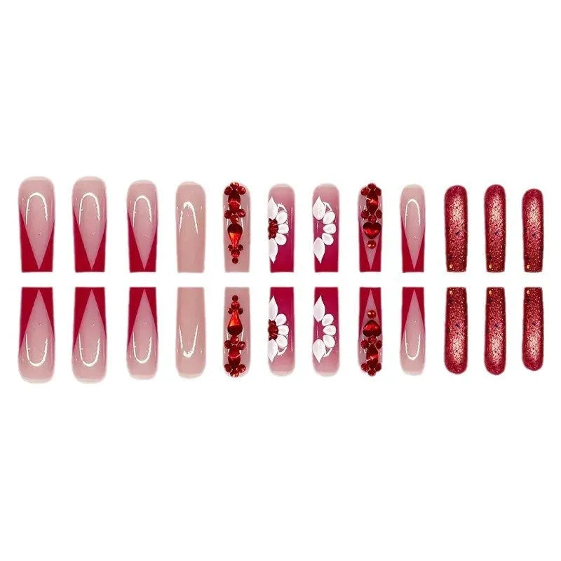 Sweet floral pattern fake nails with prismatic red diamond finish on long European square shape.