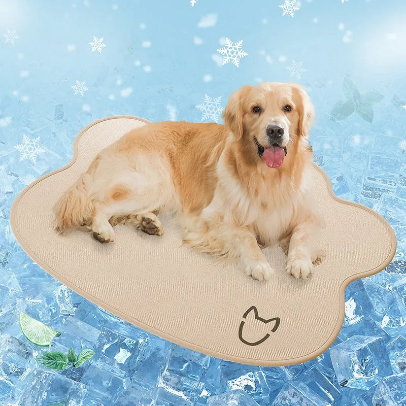 Ice silk pet cooling mat for dogs in a simple dog head shape, shown in a light grey colour on a wooden floor.
