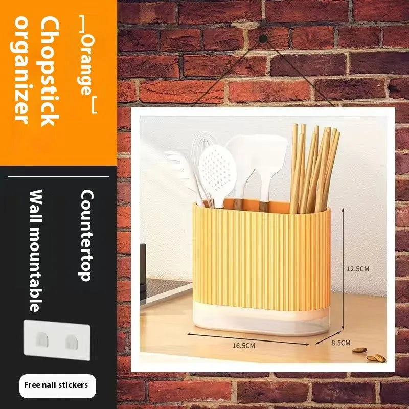 Plastic wall-hanging chopsticks holder tube in kitchen with utensils