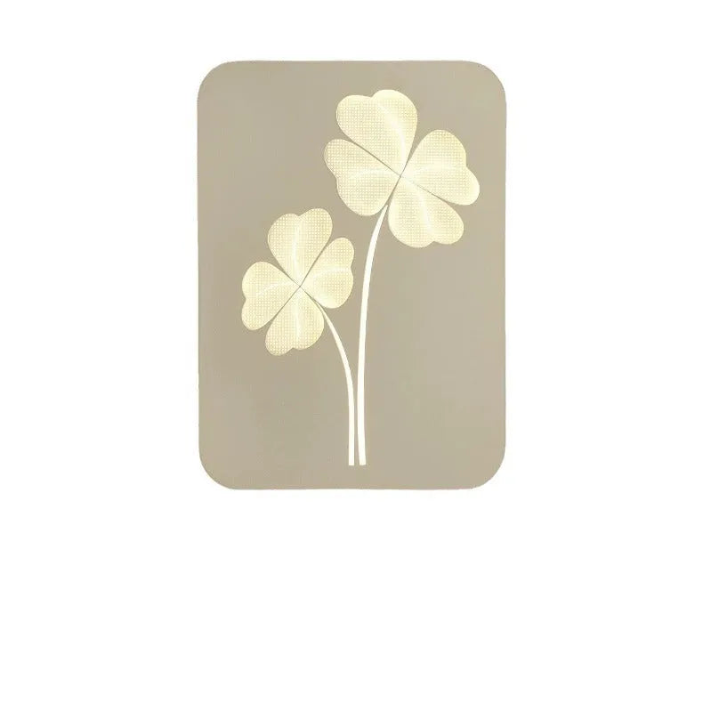 Modern cream coloured bedside lamp with acrylic shade and iron base on a wooden table.