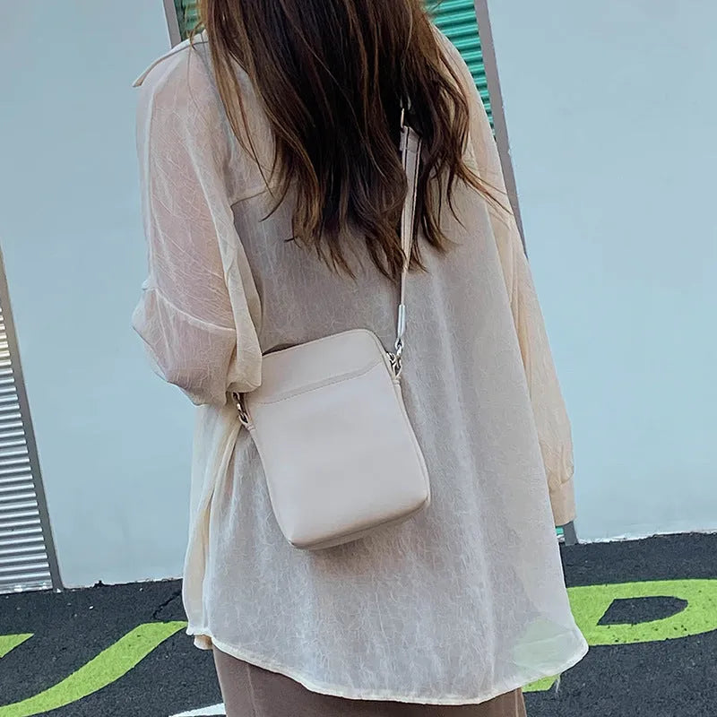 Solid colour PU crossbody shoulder bag for women in beige, showing compact size.