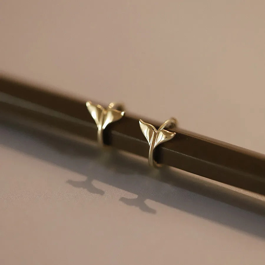 Women's sterling silver fishtail earrings in gold colour with smooth band design