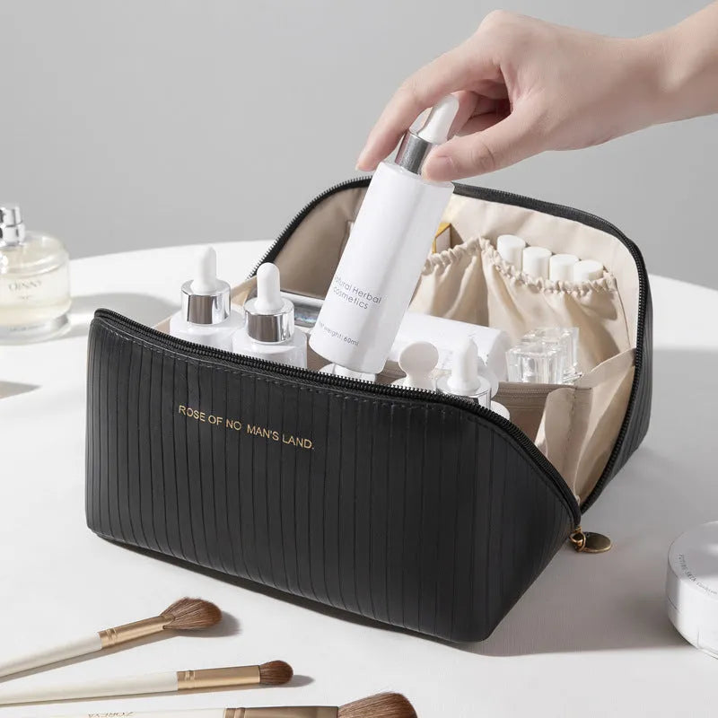 PU leather vertical pattern pillow makeup bag with cubic shape in travel setting