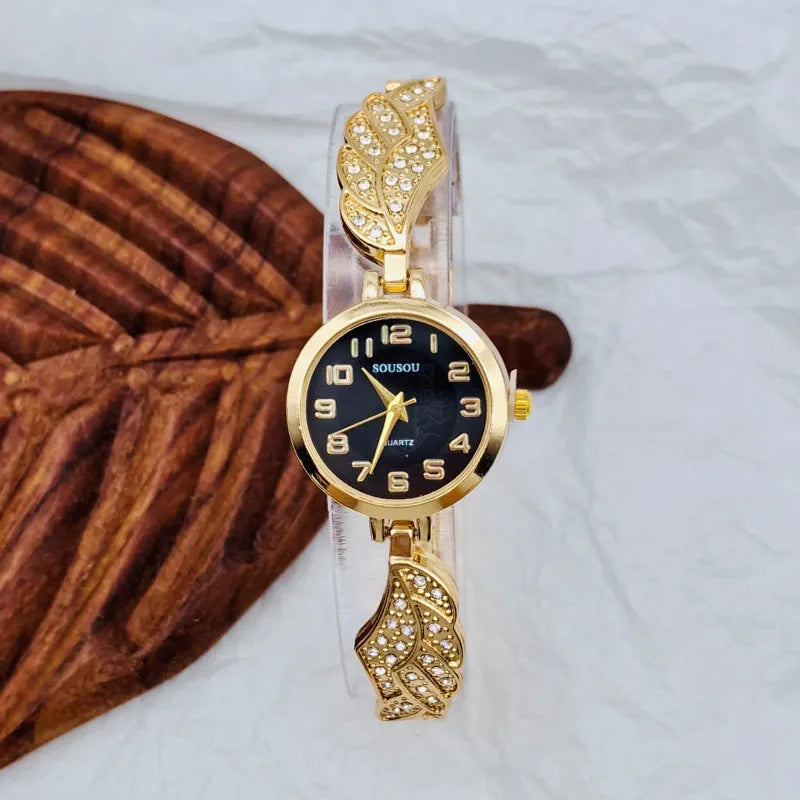 Women's stainless steel watch with round dial on wrist, showing gold face colour option and vachette clasp.