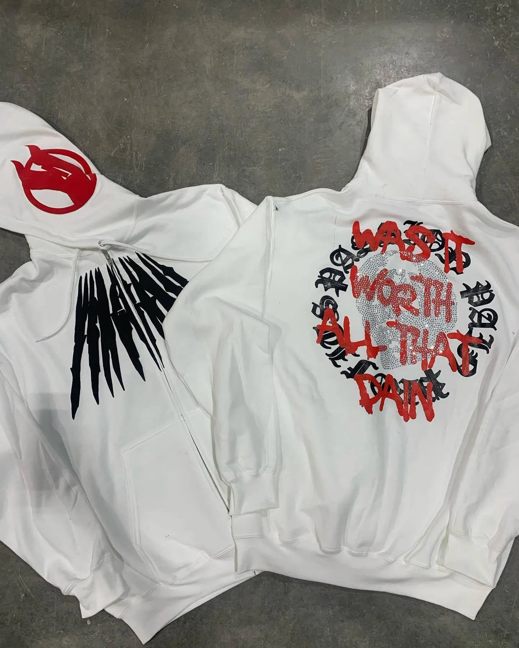 Black loose hooded cardigan sweatshirt with white printed skull letter pattern and rhinestone details.