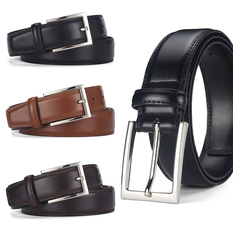 Men's classic black genuine leather belt with a silver-toned alloy pin buckle on a flat surface.