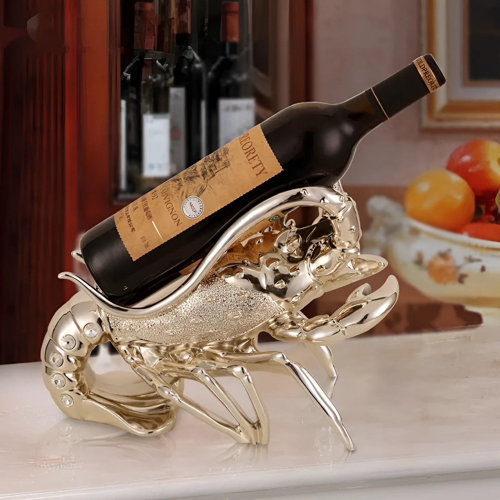 Rose gold and silver lobster-shaped plastic and resin wine rack ornament on a tabletop.