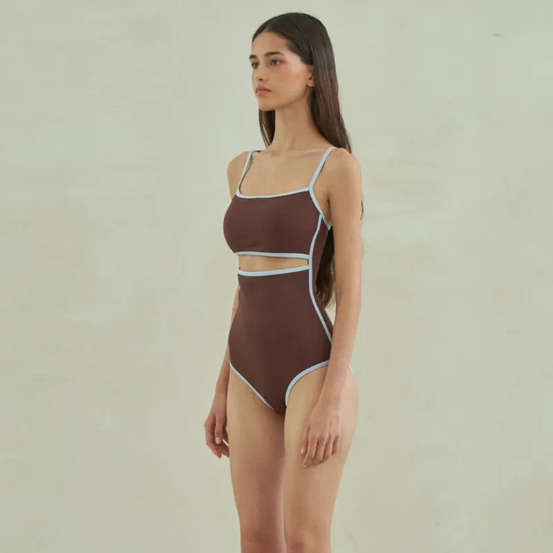 Brown triangle top one-piece swimsuit for women on a hanger.