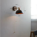 Nordic style wooden bedside wall lamp mounted on a light-coloured wall.