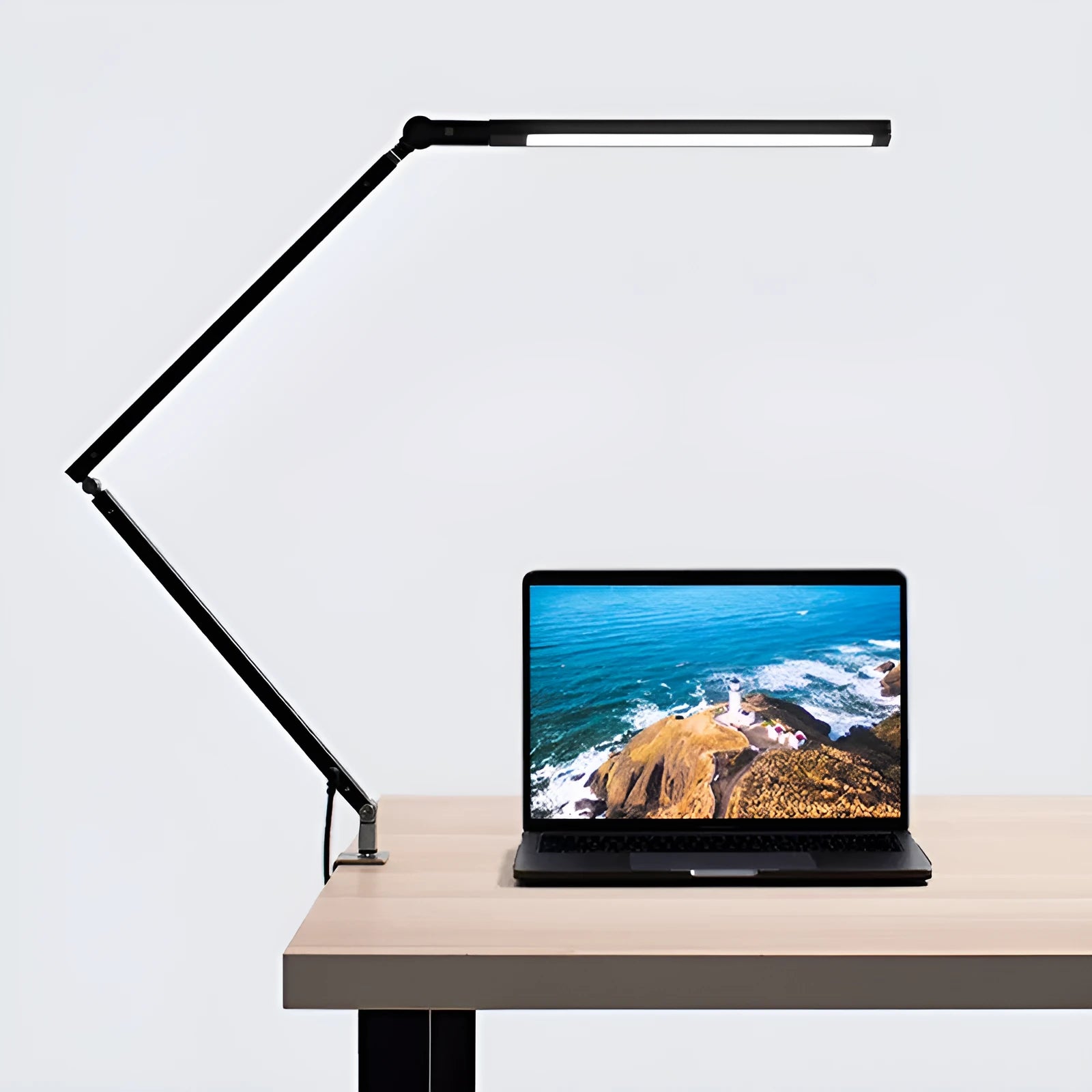 A modern aluminium clip-on desk lamp with a flexible arm and remote control, shown in dazzling black finish.