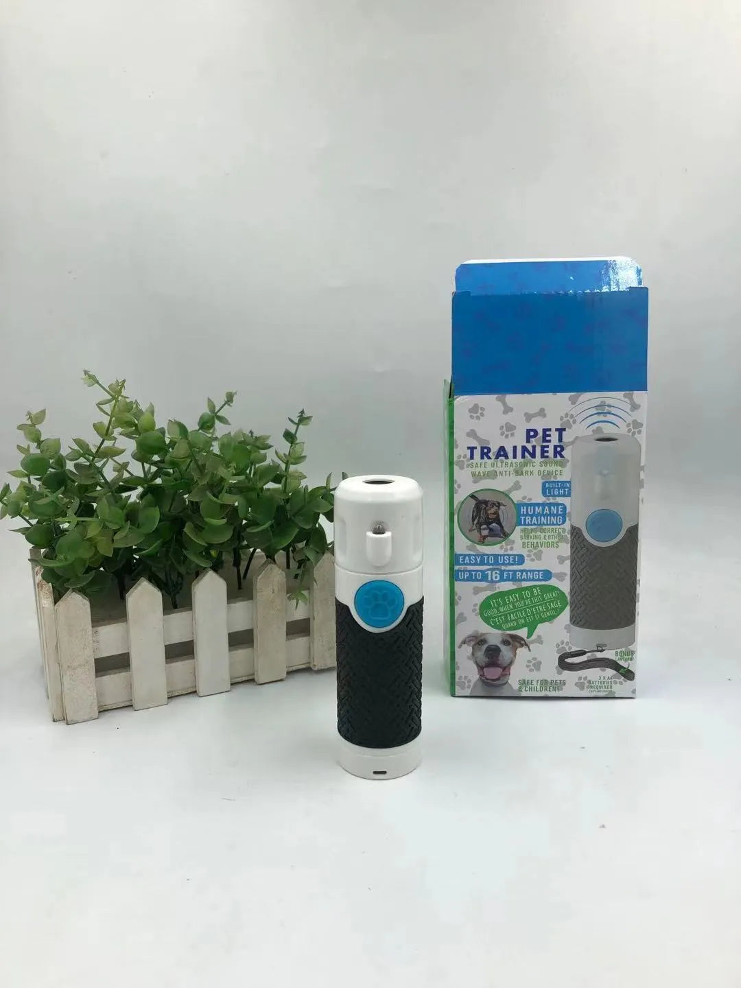 White ABS plastic handheld ultrasonic dog trainer for barking control.