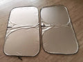 Universal fit aluminium foil car windscreen sunshade showing titanium silver reflective surface.