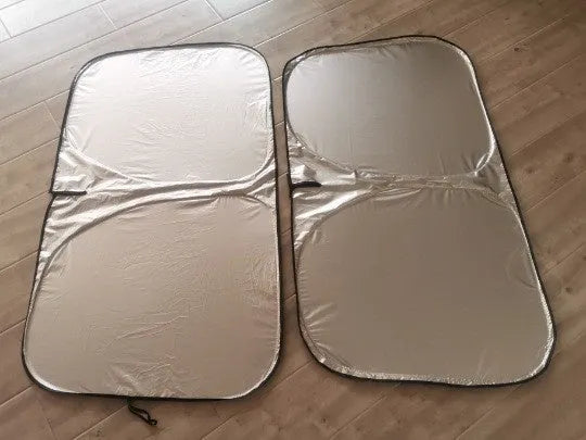 Universal fit aluminium foil car windscreen sunshade showing titanium silver reflective surface.