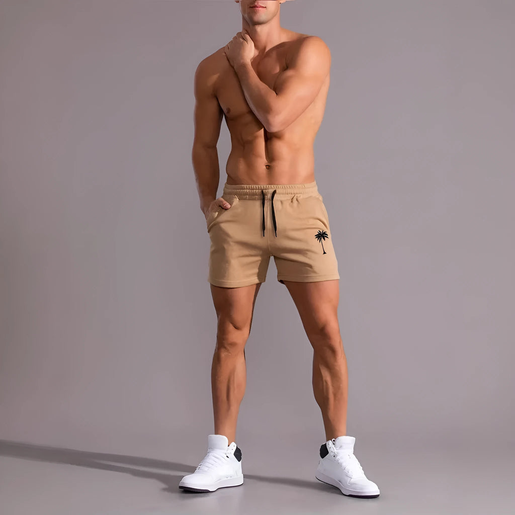 Men's khaki sports shorts with a coconut leaf print, showing straight-leg cut.