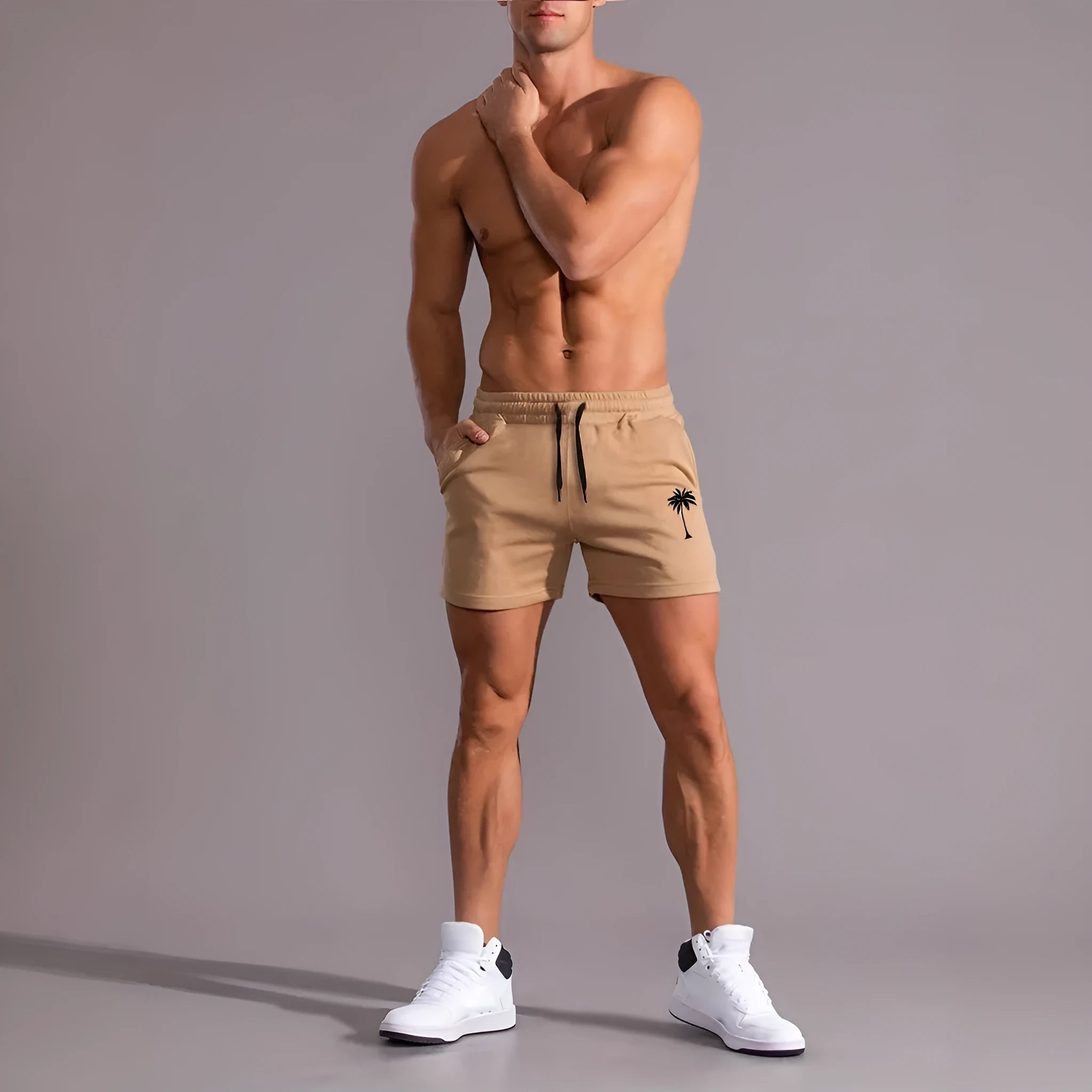Men's khaki sports shorts with a coconut leaf print, showing straight-leg cut.