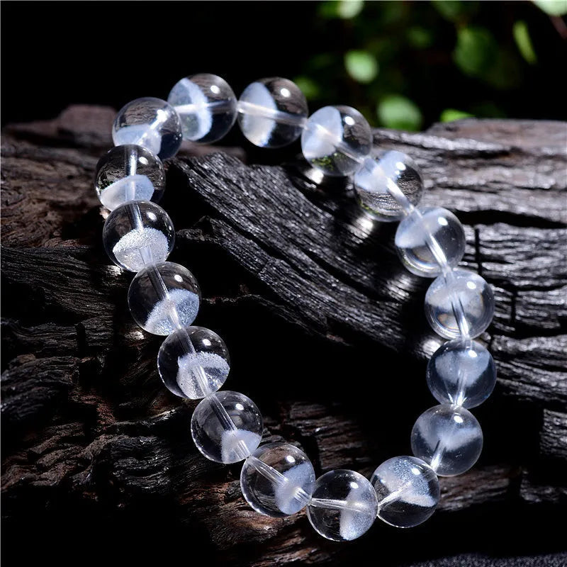 Women's original design white crystal pyramid bracelet with Ruyi charm on wrist.