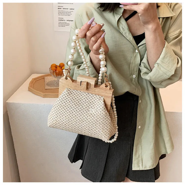 Women's straw woven shoulder bag with pearl chain strap in horizontal square shape