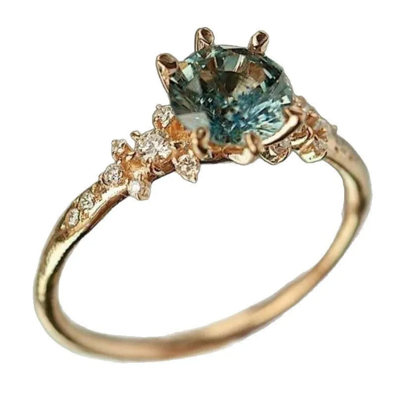 Creative geometric gold plated ring with claw-set zircon stone on a hand.