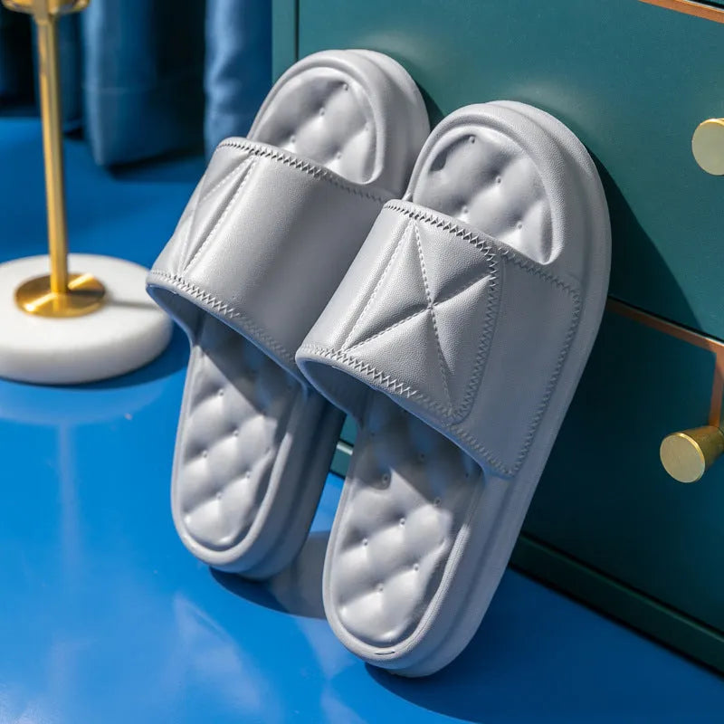 A pair of soft EVA bathroom slippers with a thick, textured non-slip sole in a choice of colours.