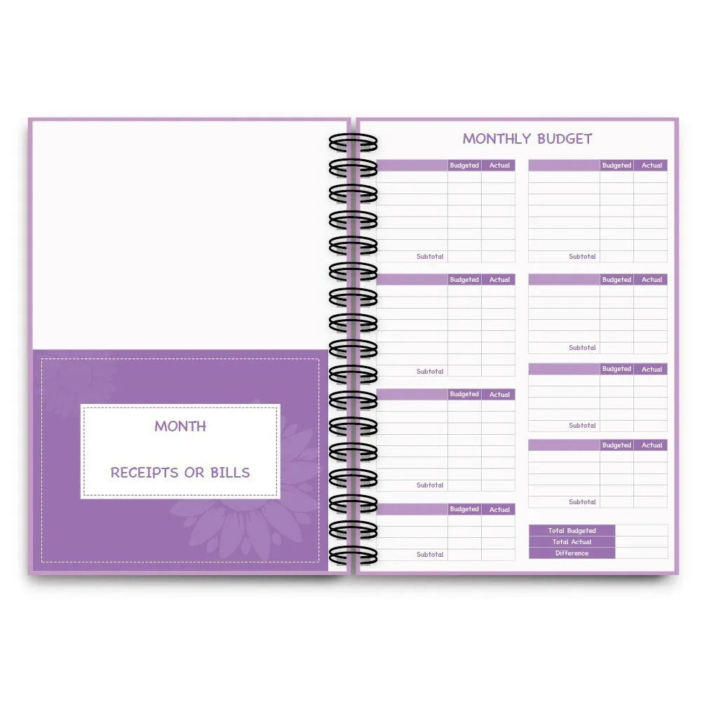 J12 purple coil-bound budget notebook with financial planning stickers and paper clips laid out.