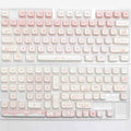 Full set of PBT mechanical keyboard keycaps showing uniform 26mm size and textured surface