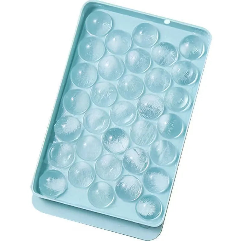 Blue silicone ice cube tray with lid showing 33 round moulds for homemade ice