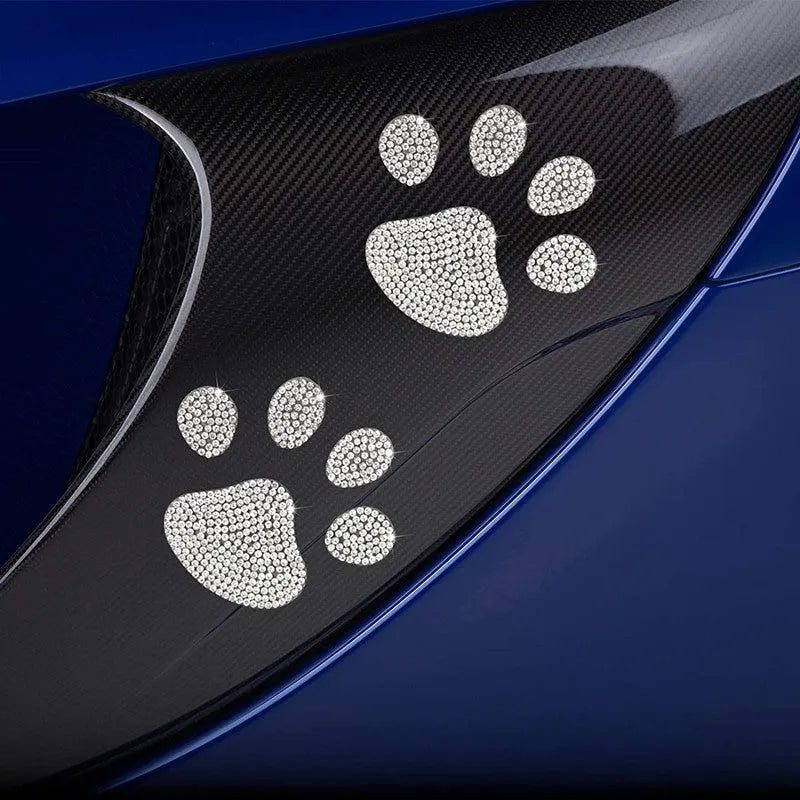 Glass car sticker with diamond detailing in butterfly or bear claw design, 7cm by 6cm.