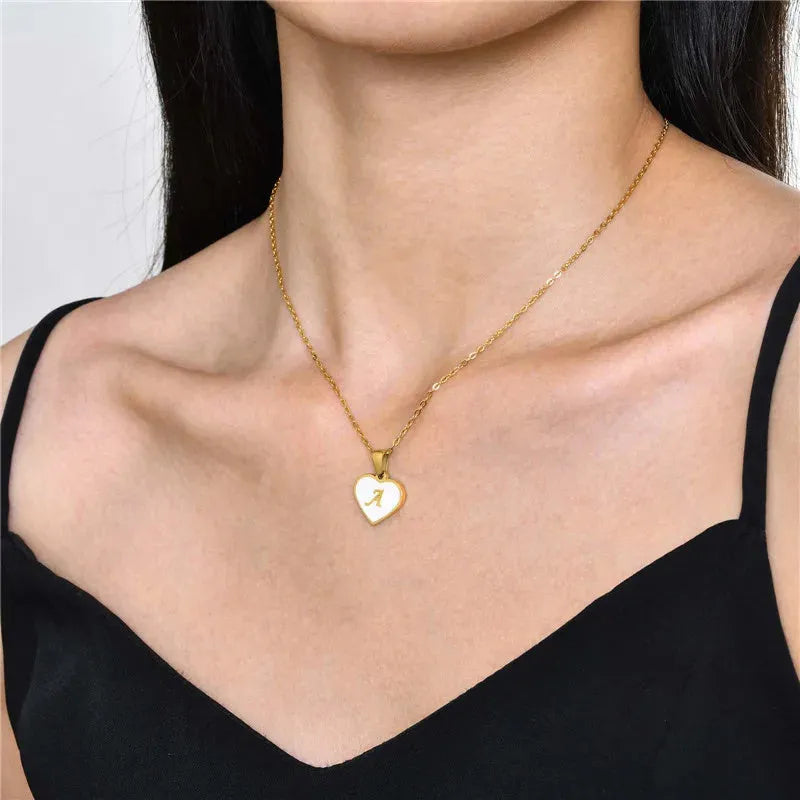 Gold plated heart necklace with white shell detail on an adjustable chain