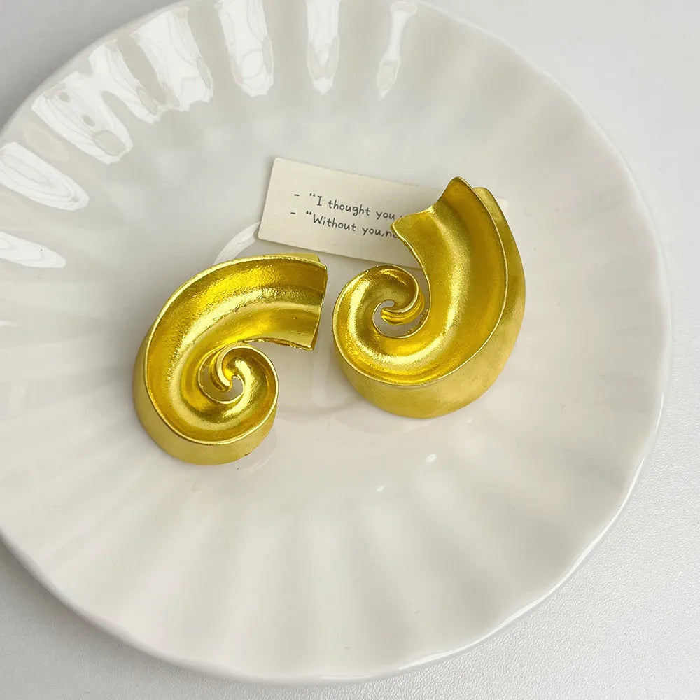 Retro geometric alloy ear studs in gold or silver colours measuring 5cm
