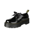 Women's black thick-soled leather-style lace-up shoes with ribbon and cross strap details on a white background.