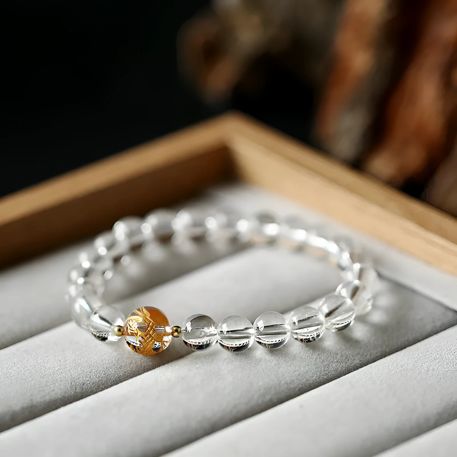 Unisex geometric beaded bracelet with obsidian, white crystal, and a gold dragon bead on a black background