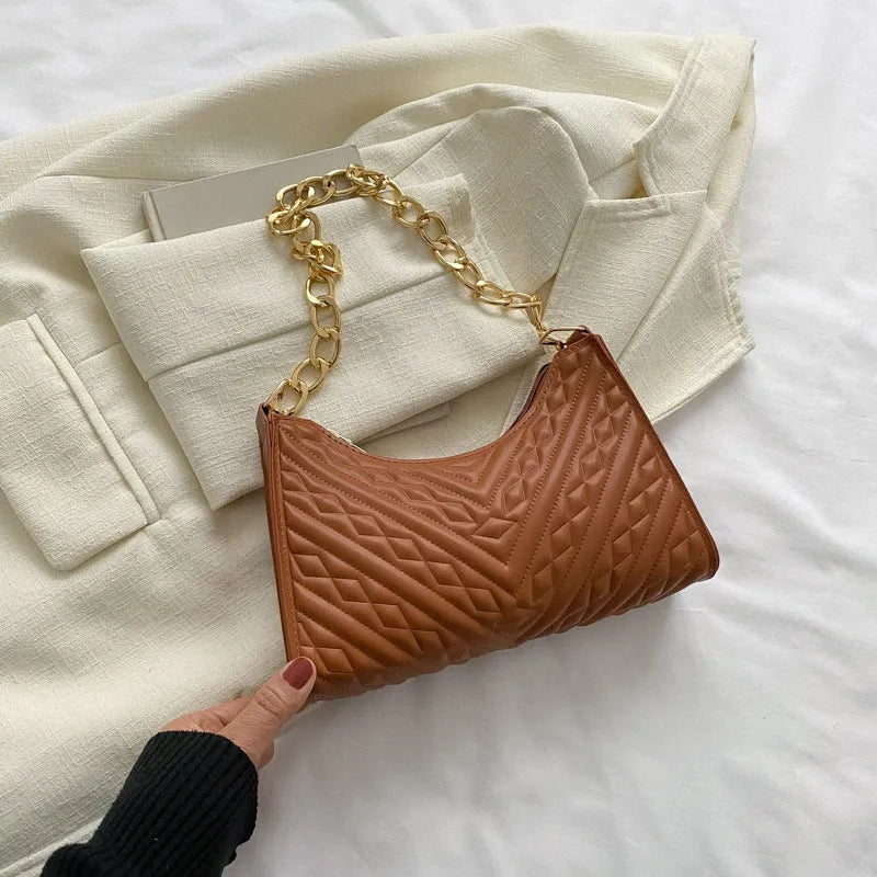 Brown pleated chain strap baguette shoulder bag with a vertical square shape and soft carry handle.