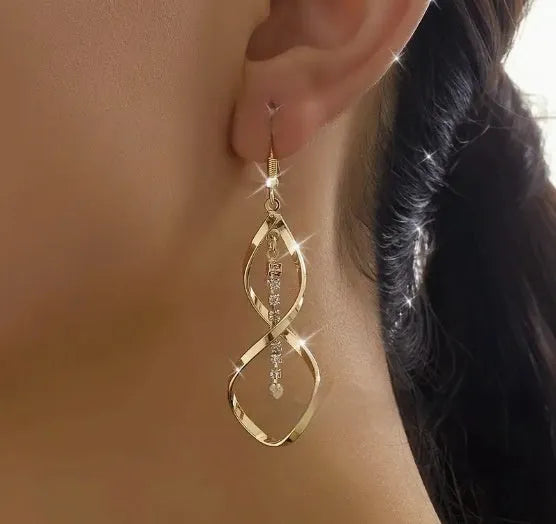 Gold geometric spiral design alloy earrings with elliptical shape