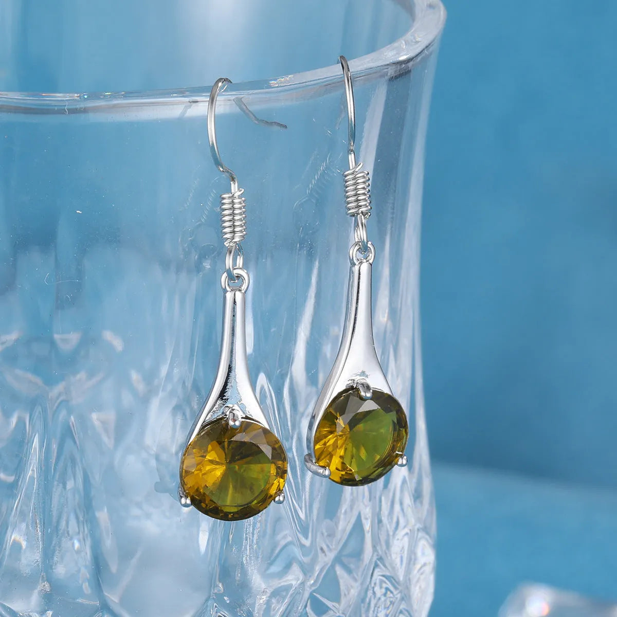 Olive green drop shape fashion earrings with a retro minimalist style.