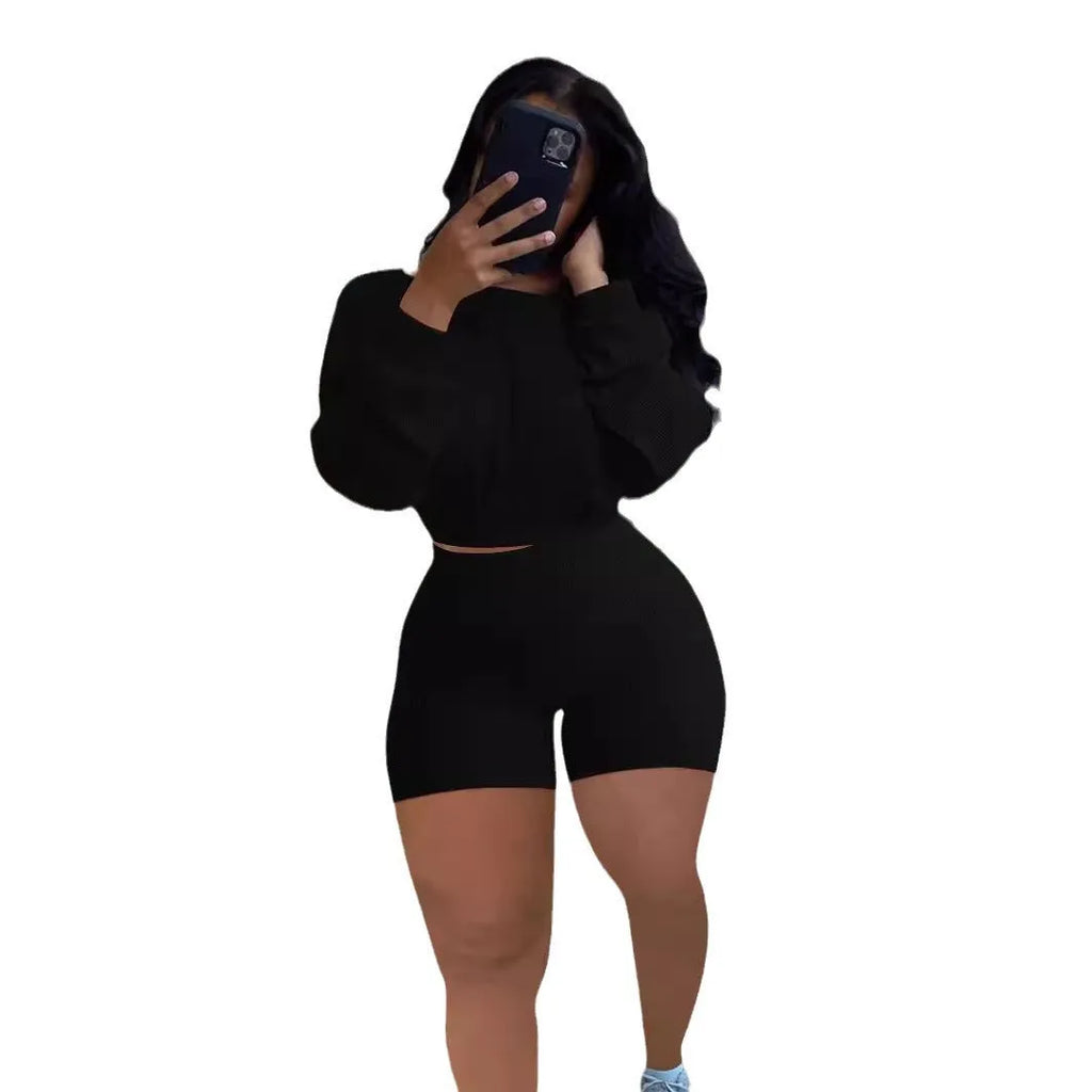 Women's solid colour off-the-shoulder long sleeve top and shorts two-piece set with sunken stripe pattern.