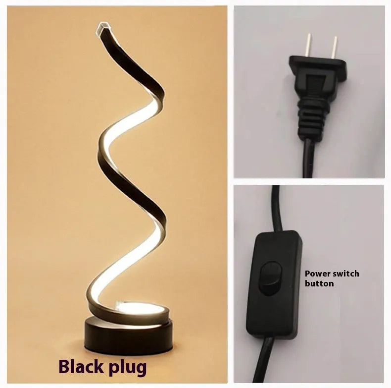 Minimalist black LED table lamp with aluminium shade on bedside table